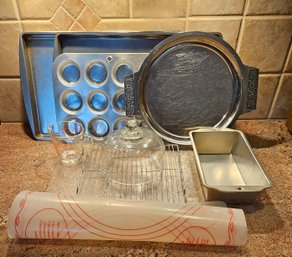 A Collection Of Baking Sheets, Muffin Pan, Cutting Board, Stainless Steel Serving Platter And More