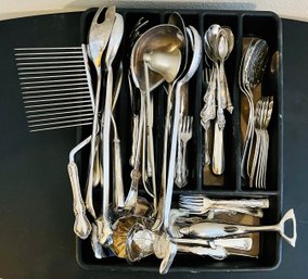 Assortment Of Silver Utensils And Kitchen Essentials