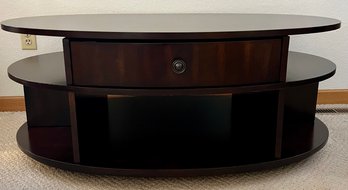 Dark Wood Rising Coffee Table With Drawer Shelve Around The Oval