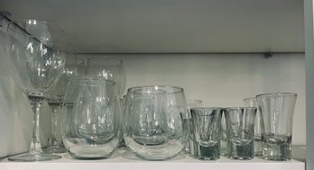 Variety Of Glassware Including Assorted Wine Glasses And Shot Glasses