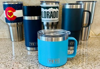 Assortment Of YETI Mugs And Travel Cups