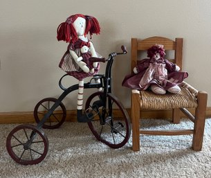 Two Dolls On Tricycle And Wicker Chair