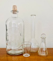 Assorted Lot Of Apothecary Glass Bottles & Measuring Glass Including Large Alcohol Bottle