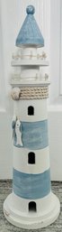 White And Blue Striped Wooden Lighthouse