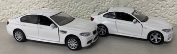 Two Small White BMW M5 Model Cars