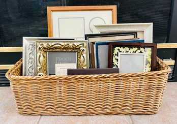 Wicker Basket With An Assortment Of Picture Frames