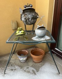 Green Wrought Iron Patio Side Table With Metal Frog Statues And Small Pots