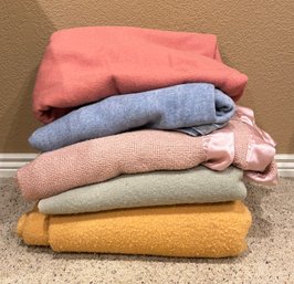 Assortment Of Pastel Colored Blankets