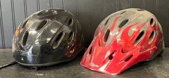 Pair Of Black And Red Bicycle Helmets