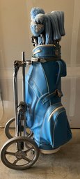 Set Of Golf Clubs In Light Blue Bag With Bag Boy Wheeled Cart And Matching Club Covers