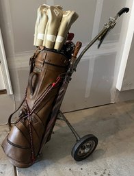 Set Of Titalist Golf Clubs In Brown Leather Bag With Cart And Club Covers