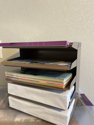 Paper Filing Rack With Reams Of Printer Paper And Packs Of Colored Paper