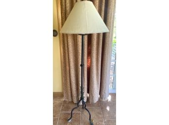 A Nice Standing Floor Lamp With Tripod Legs And Oatmeal Shade