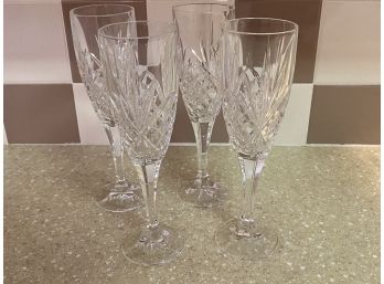 A Set Of Four Cut Crystal Champagne Glasses