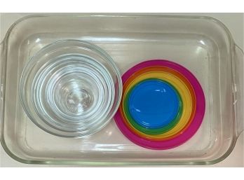 A Large Pyrex Baking Dish And Glass Nesting Bowls With Lids