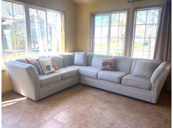 A Nicely Upholstered L-shaped Sofa Set With Cabin Style Accent Pillows