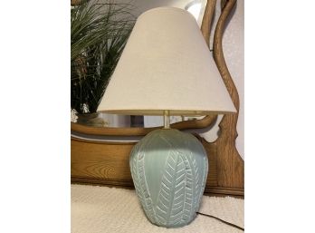 A Nice Blue Lamp With Foliate Design And Cream Lamp Shade