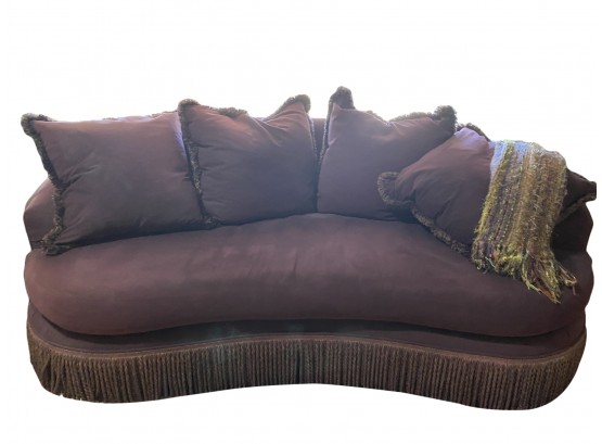 A Beautiful Kidney Shaped Upholstered Club Sofa With Fringe And Down Filled Cushions