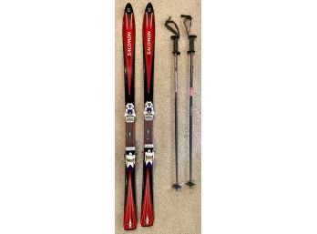 Salomon Red And Black Skiis And Colt Sport Poles