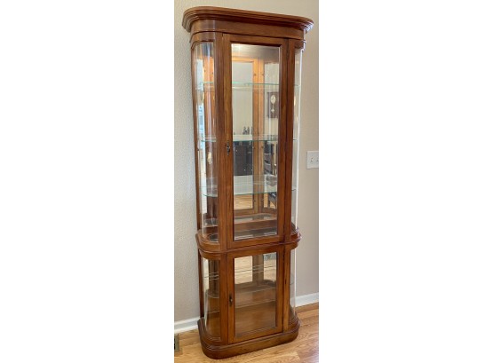 Pulaski Furniture Corp. Curved End Glass And Wood Lighted Curio Cabinet