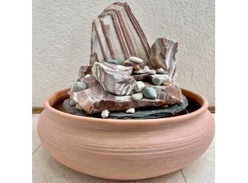 A Sand Stone Water Feature In Plastic Terracotta Base