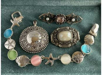 Two Pendants, One Pin, And One Seashell Magnet Bracelet