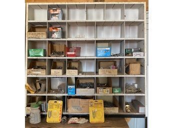 A Large Cubby Shelf Of Miscellaneous Hardware Including Nails, Screws And More