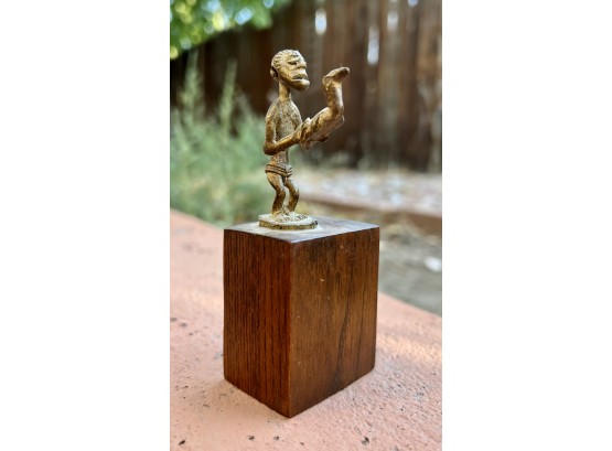Miniature Statue On Wood Block