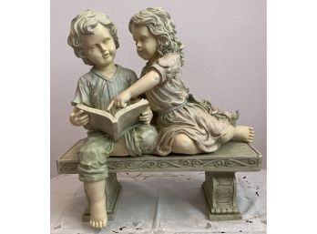 Statue Of Girl And Boy Reading A Book