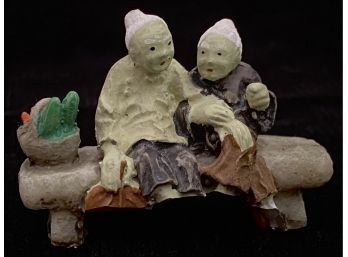 Tiny Grandmother Figurines Sitting On A Bench Figurine