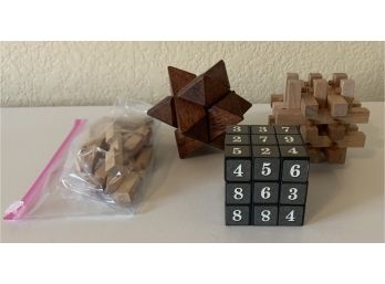 An Assortment Of 4 Puzzle Games Inc. A  Sudoku Puzzle Cube And More.