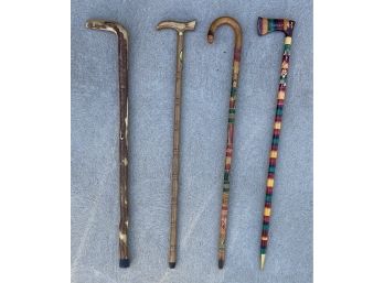 4 Wooden Canes With Various Colors And Shapes
