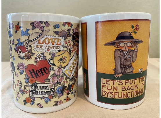 Pair Of Two Mary Engelbreit Mugs Including “lets Put The Fun Back In Dyfunctional” And “Life Is Just A Bow