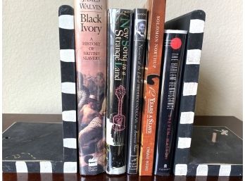 Collection Of Books With Black & White Bookends Including New Song In A Strange Land & 12 Years A Slave