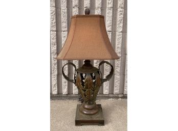 Metal Base Lamp With Handles And A Brown Bell Shaped Shade