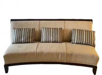 Ashley Furniture Curved Couch With Three Decorative Striped Pillows