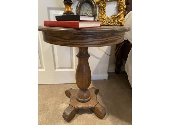Round Top Tiger Oak Pedestal Table And 6 Items On Top, 2 Of Which Are Cherub Picture Frames