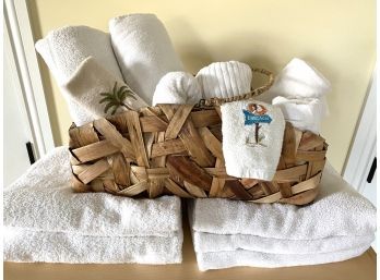 Decorative Grouping Of White Cotton Towels In Woven Basket