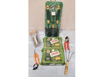 Collection Of Assorted Gardening Tools Including Trowels, Clippers, And Fertilizer Spikes