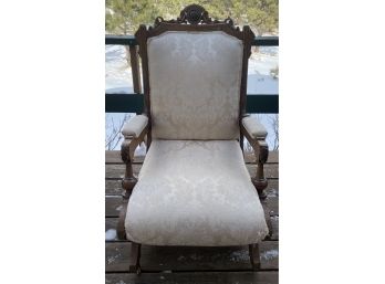Ornately Carved Antique Gothic Style Rocking Chair With Brocade Upholstery