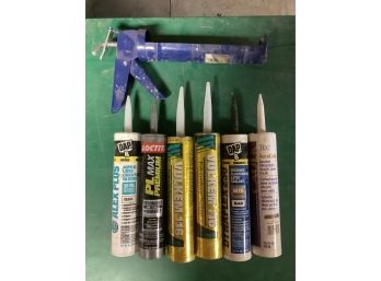 6 Unopened Tubes And Caulk Gun