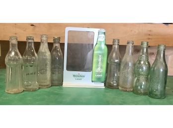 8 Glass Soda Bottles And A Heineken Picture Frame