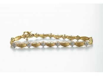 Beautiful 10K Gold Tennis Bracelet With Diamond Chip Flower Detail