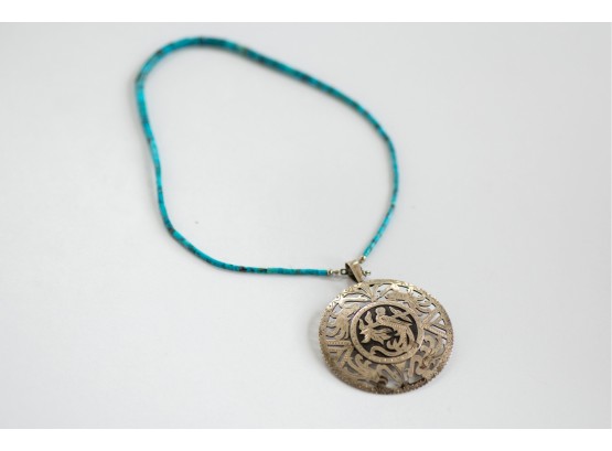 A Beautiful Sterling Silver Medallion Pendant On Hand Cut Turquoise Bead Necklace