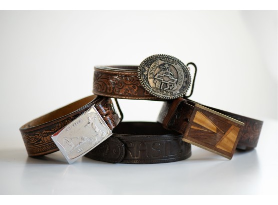 A Grouping Of Four Vintage Tooled Leather Belts With Buckles