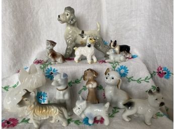 A Large Collection Of Dog Miniatures In A Variety Of Mediums Including Porcelain, Agate Slice, And Bone China