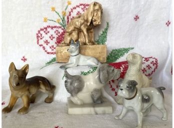 A Large Collection Of Wonderful Dog Figurines In A Variety Of Mediums Including Porcelain & Stone