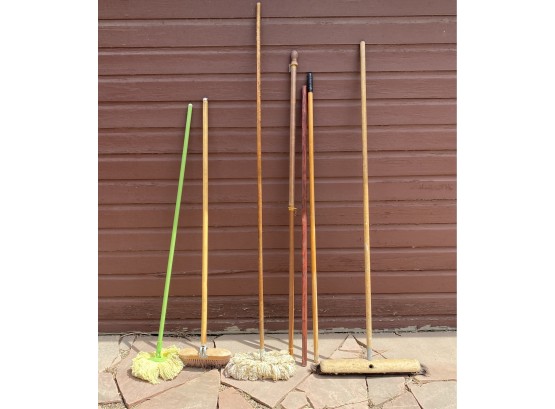 Grouping Of Push Brooms Mops And Flag Poles