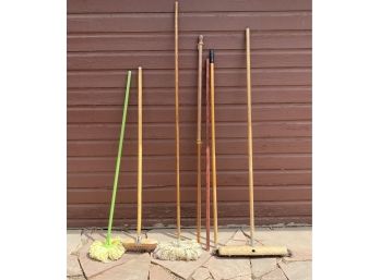 Grouping Of Push Brooms Mops And Flag Poles