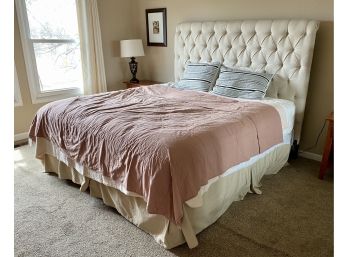 Lovely Upholstered Tufted Cream Colored Headboard With Mattress Box Spring Metal Frame And Linens